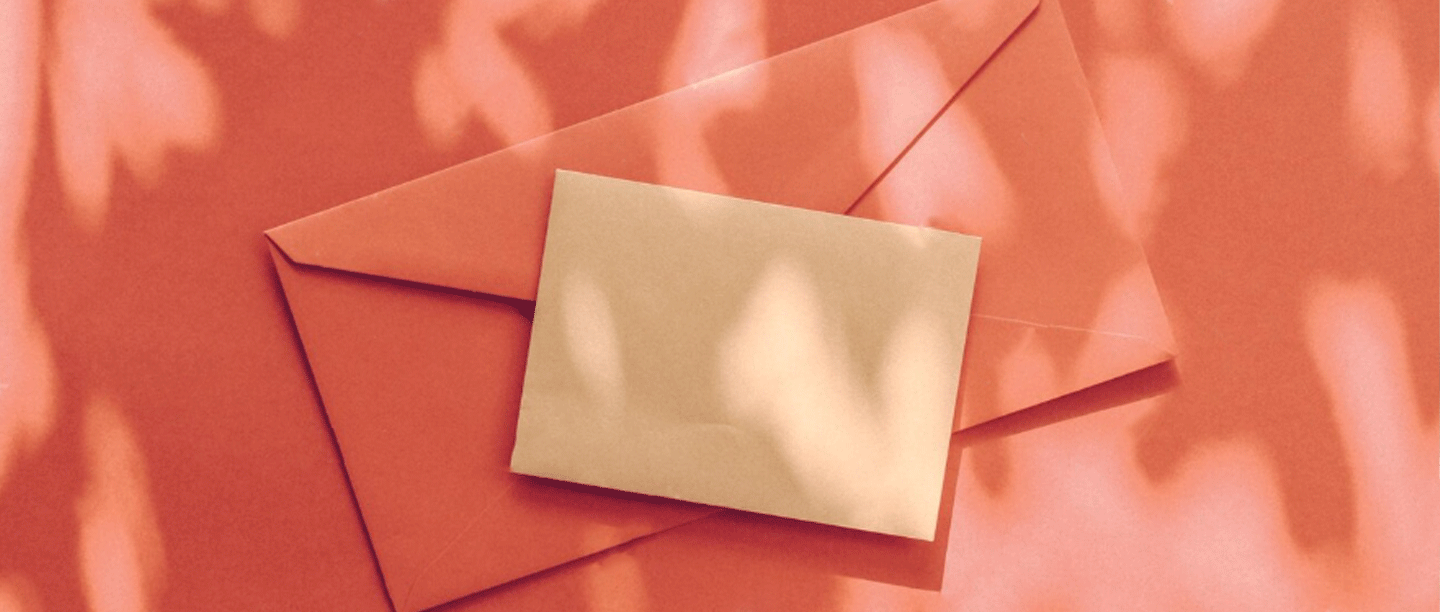 envelopes stacked on orange background