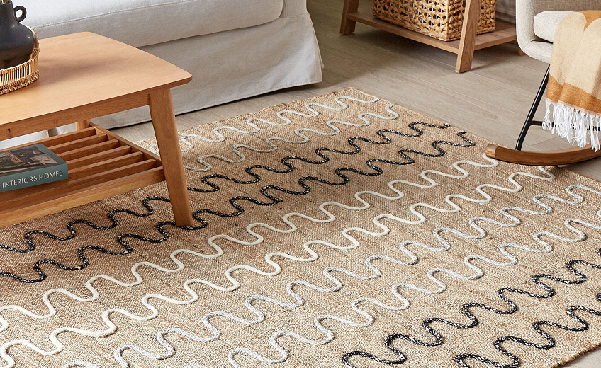 Natural handwoven jute rug placed under living room furniture