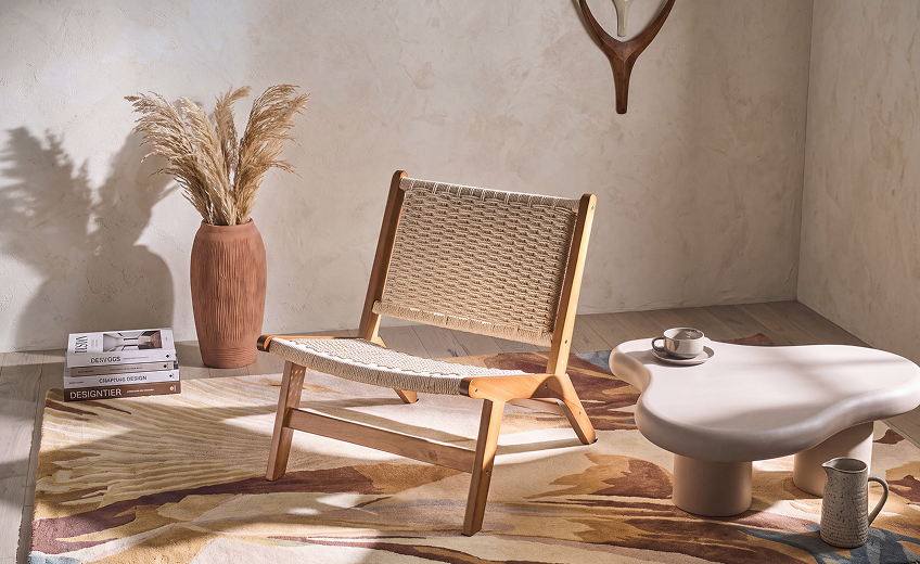 mediterranean-style low seat rattan armchair in an atmospheric interior