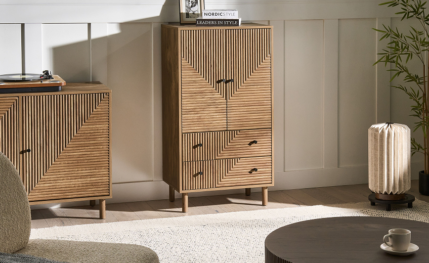 Light pine wood sideboard with textured doors in a Mediterranean style setting